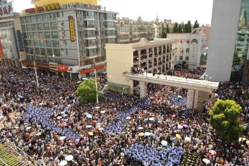 Police and protestors gather outside the local government offices in the city of Qidong, near Shanghai, on July 28. Protests against environmental degradation have increased in China, where three decades of rapid and unfettered industrial expansion have taken their toll