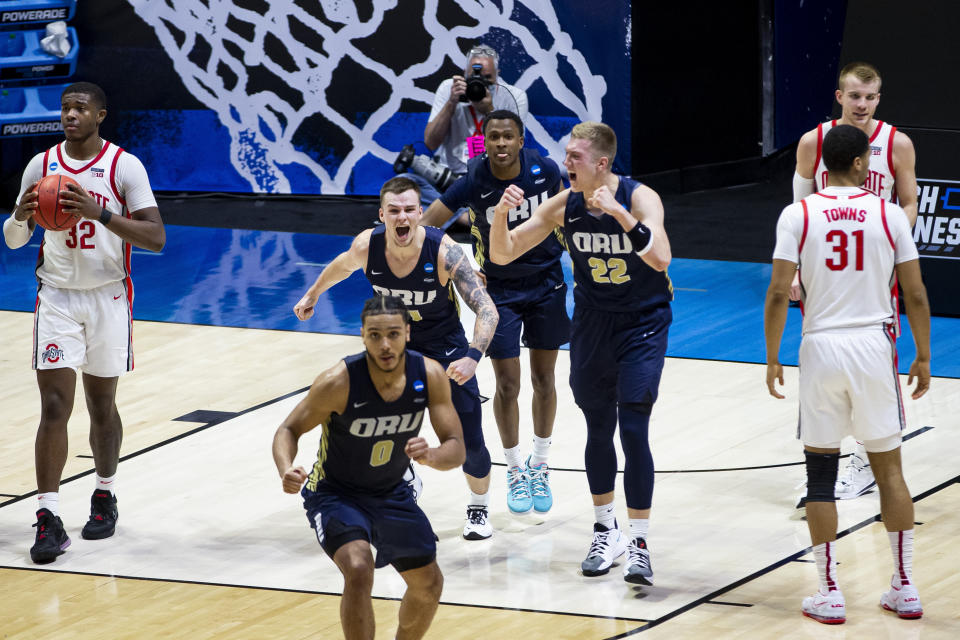 Oral Roberts players celebrate after beating Ohio State in a first-round game in the NCAA men's college basketball tournament, Friday, March 19, 2021, at Mackey Arena in West Lafayette, Ind. (AP Photo/Robert Franklin)