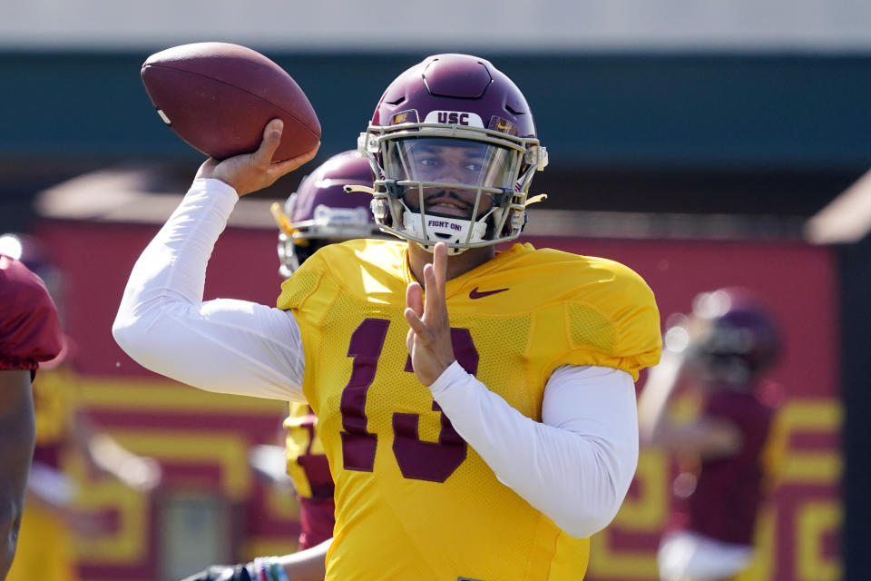 FILE - Southern California quarterback Caleb Williams throws during an NCAA college football practice on April 5, 2022, in Los Angeles. Williams is expected to be a Heisman Trophy frontrunner after following coach Lincoln Riley from Oklahoma to USC. (AP Photo/Marcio Jose Sanchez, File)