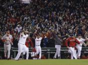 Boston Red Sox players rush onto the field after defeating the St. Louis Cardinals in Game 6 of baseball's World Series Wednesday, Oct. 30, 2013, in Boston. The Red Sox won 6-1 to win the series. (AP Photo/Elise Amendola)