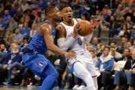 Nov 12, 2017; Oklahoma City, OK, USA; Oklahoma City Thunder guard Russell Westbrook (0) drives to the basket in front of Dallas Mavericks guard Dennis Smith Jr. (1) during the fourth quarter at Chesapeake Energy Arena. Mark D. Smith-USA TODAY Sports