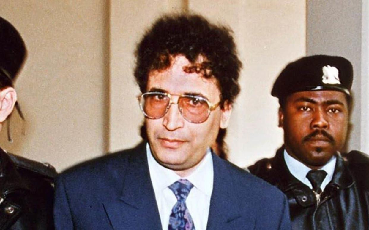 (FILES) In this file photo taken on February 18, 1992 convicted Lockerbie bomber Abdelbaset Ali Mohmet al-Megrahi (C) is escorted by security officers. - Five judges at Scotland's highest court of criminal appeal on January 15, 2021 issue their ruling in a posthumous appeal by the family of Lockerbie bomber Abdelbased Ali Mohmet al-Megrahi. (Photo by MANOOCHER DEGHATI / FILES / AFP) (Photo by MANOOCHER DEGHATI/FILES/AFP via Getty Images) - MANOOCHER DEGHATI/AFP via Getty Images