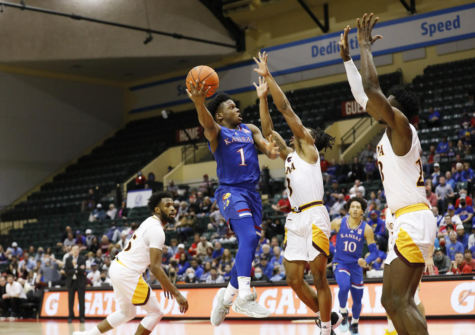 Kansas guard Joseph Yesufu (1) lays up a shot in front of Iona guard Ryan Myers, center right, and forward Nelly Junior Joseph, right, during the second half of an NCAA college basketball game Sunday, Nov. 28, 2021, in Lake Buena Vista, Fla. (AP Photo/Jacob M. Langston)