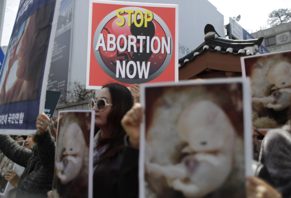 Pro-life demonstrators hold banners during a rally supporting South Korea's anti-abortion regulations outside of the Constitutional Court in Seoul, South Korea, Thursday, April 11, 2019. In a major reversal, South Korea's Constitutional Court on Thursday ordered the easing of the country's decades-long ban on abortions, one of the strictest in the developed world. (AP Photo/Lee Jin-man)