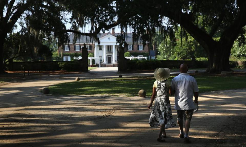 A couple walk through the grounds of the Boone Hill plantation in Mount Pleasant, South Carolina.