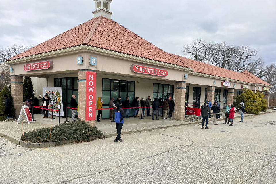 Customers wait in line outside the Fine Fettle marijuana dispensary in Willimantic, Conn., Tuesday, Jan. 10, 2023, for the opening of legal sales of recreational marijuana in Connecticut. As many as 40 dispensaries, along with dozens of other cannabis-related businesses, are expected to eventually open in Connecticut by the end of this year. (AP Photo/Pat Eaton-Robb)