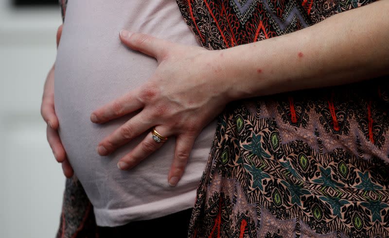 FILE PHOTO: Stephanie Bowers who is 8 months pregnant poses for a photograph outside her home, as the spread of the coronavirus disease (COVID-19) continues, Manchester