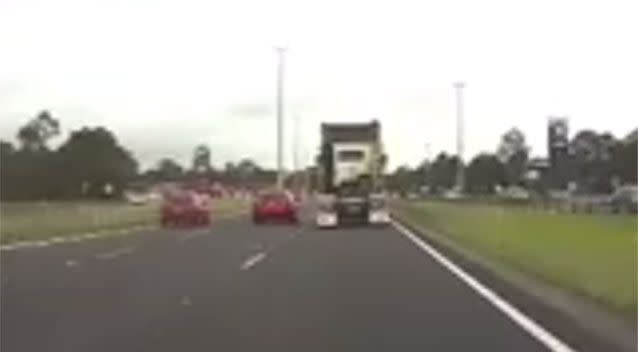 The car travels to the left of the truck moments before the prime mover takes its place in the next lane over. Picture: Dash Cam Owners Australia/Facebook