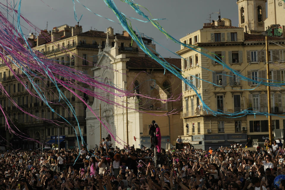 People gather as the Belem, the three-masted sailing ship bringing the Olympic flame from Greece, enters the Old Port in Marseille, southern France, Wednesday, May 8, 2024. The torch was lit in Greece last month before it was officially handed to France. The Paris 2024 Olympic Games will run from July 26 to Aug.11, 2024. (AP Photo/Thibault Camus)