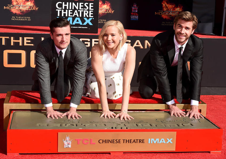 <p>To mark the opening of the fourth and final installment in <i>The Hunger Games </i>series, the star trio is immortalized in cement at the Chinese Theatre in Hollywood on Oct. 31, 2015. <i>(Photo:Steve Granitz/WireImage)</i></p>