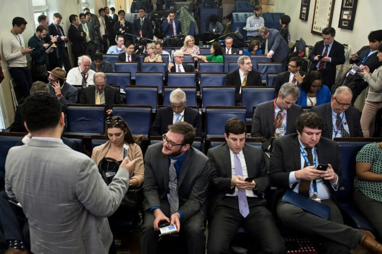 Reporters wait to try and get access to an off camera briefing with White House Press Secretary Sean Spicer instead of the normal on camera briefing at the White House on February 24, 2017, in Washington, DC