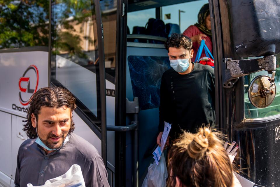 Afghan refugees arrive at a processing center in Chantilly, Va., Monday, Aug. 23, 2021, after arriving on a flight at Dulles International Airport. (AP Photo/Andrew Harnik)