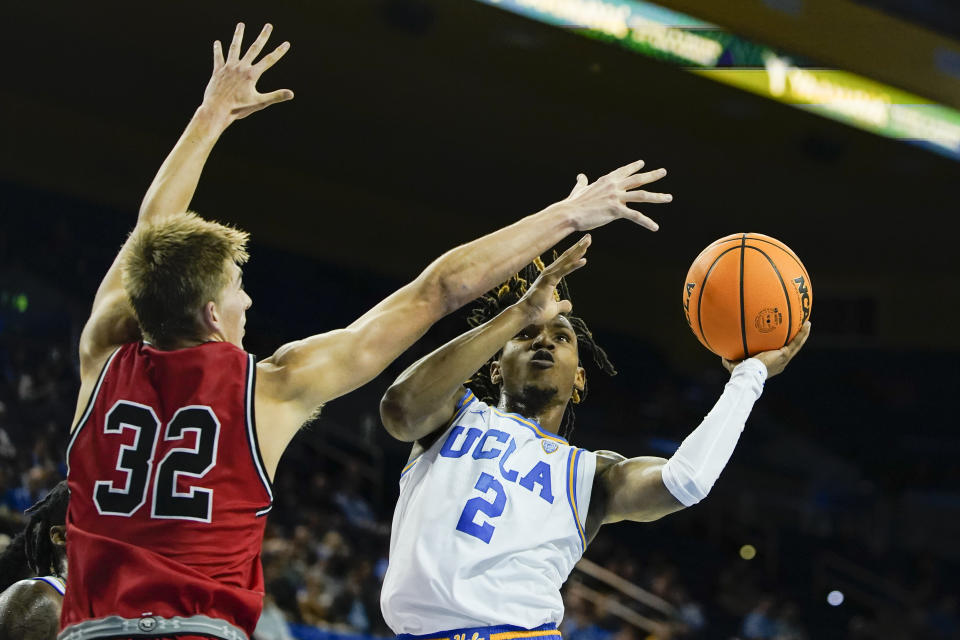 UCLA guard Dylan Andrews, right, shoots against St. Francis forward Aidan Harris during the first half of an NCAA college basketball game, Monday, Nov. 6, 2023, in Los Angeles. (AP Photo/Ryan Sun)