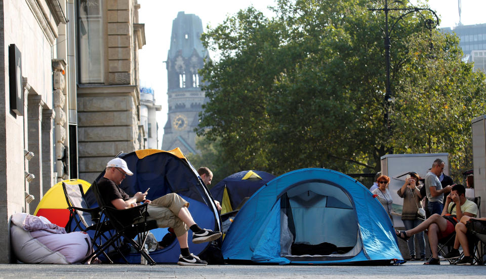 Customers wait beside their tents outside an Apple store to buy the newly released Apple iPhone 7 at Kurfuerstendamm boulevard in Berlin, Germany, September 12, 2016. REUTERS/Fabrizio Bensch