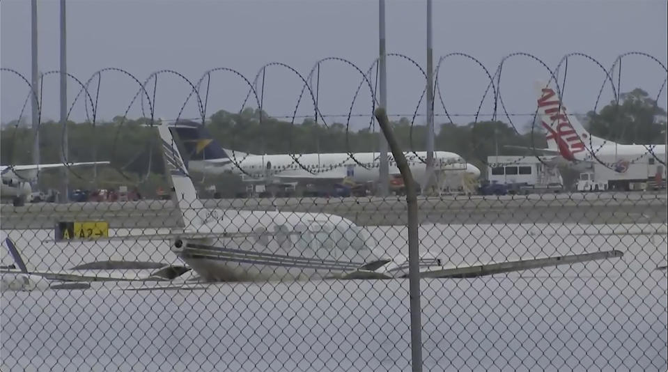 This image from a video, shows partially-submerged small planes at Cairns Airport in Cairns, Australia Monday, Dec. 18, 2023. More than 300 people were rescued overnight from floodwaters in northeast Australia, with dozens of residents clinging to roofs, officials said on Monday. (Australian Broadcasting Corp. via AP)