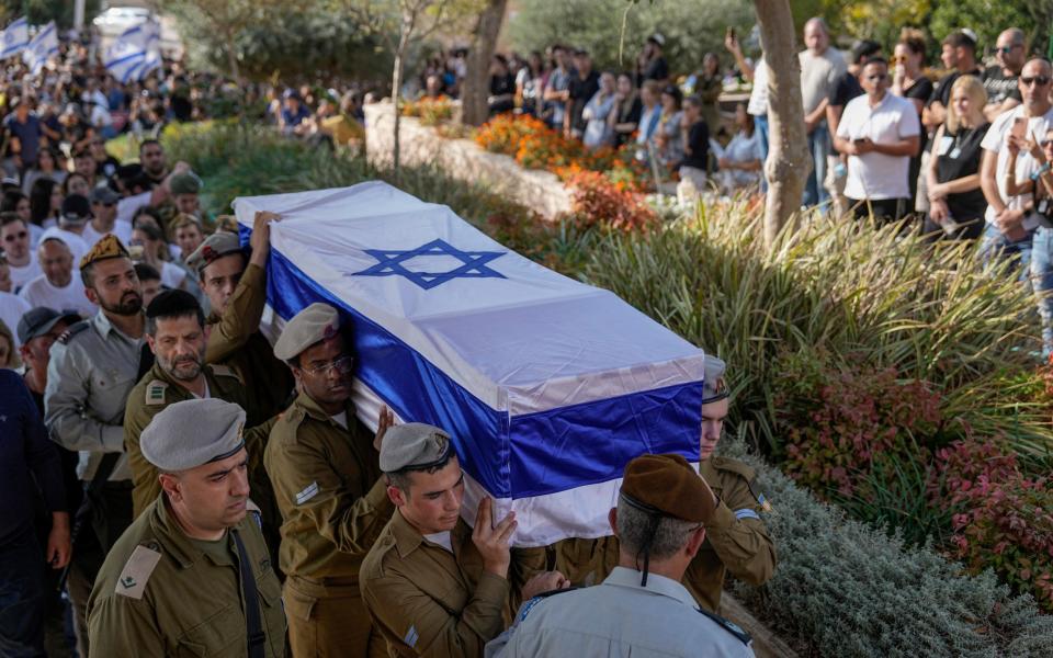 Israeli soldiers carry the flag-draped casket of Corporal. Noa Marciano, during her funeral