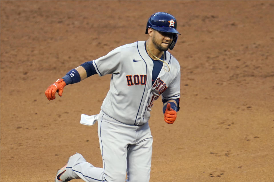 Houston Astros Yuli Gurriel jogs home on a solo home run off Minnesota Twins relief pitcher Jorge Alcala to tie a baseball game in the sixth inning Friday, June 11, 2021, in Minneapolis. (AP Photo/Jim Mone)