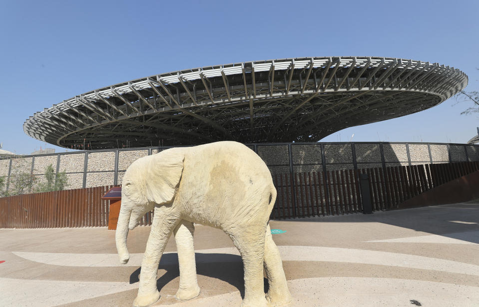 Terra, The Sustainability Pavilion is seen behind an elephant sculpture during a media tour at the Dubai World Expo site in Dubai, United Arab Emirates, Saturday, Jan. 16, 2021. With the inauguration of Expo 2020 Dubai, the next world's fair, nine months away amid the raging global pandemic that forced its postponement, organizers unveiled the site's signature pavilion to reporters for the first time on Saturday. (AP Photo/Kamran Jebreili)