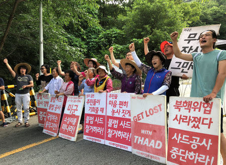 Villagers holding banners bearing their demands chant slogans during an anti-THAAD protest near an entrance of a golf course where a Terminal High Altitude Area Defense (THAAD) system is deployed, in Seongju, South Korea, July 4, 2018. REUTERS/Kim Jeong-min