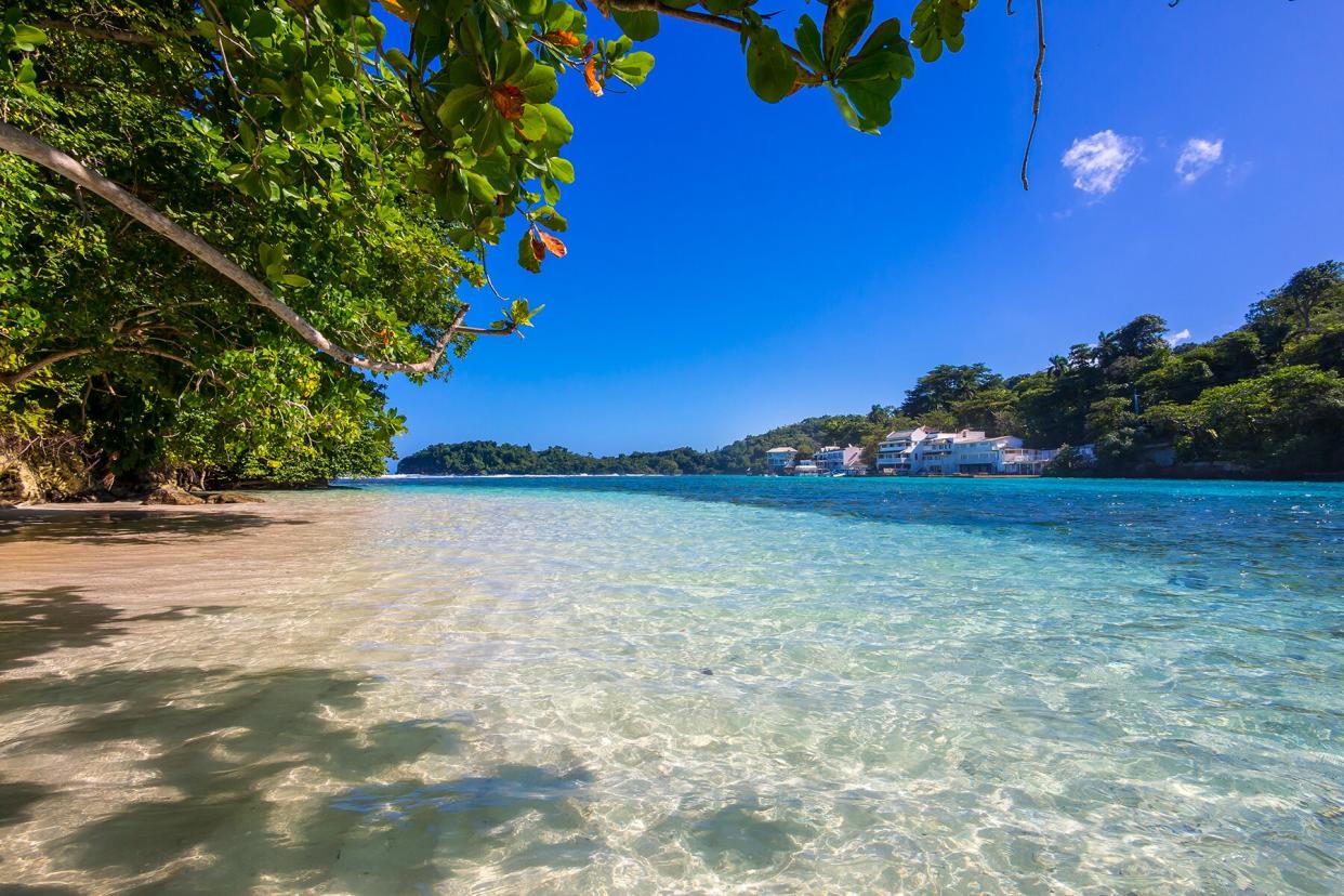 Jamaica, Port Antonio, blue lagoon with luxury villas in background