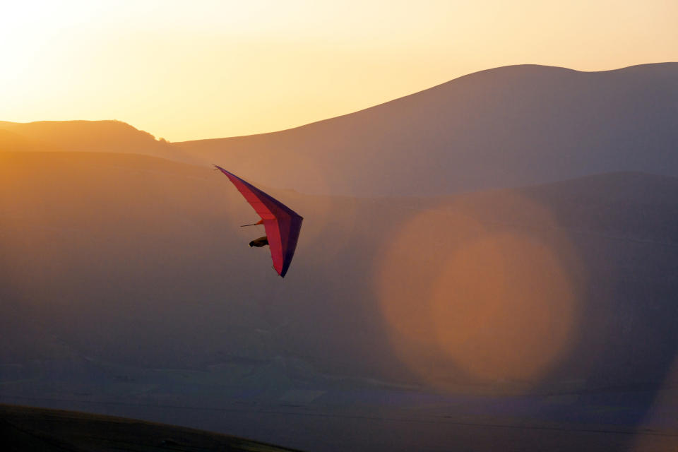 Man gliding during the sunset