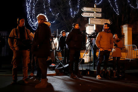 Journalists work in front of late French singer and actor Johnny Hallyday's home in Marnes-la-Coquette near Paris, France December 6, 2017. REUTERS/Benoit Tessier