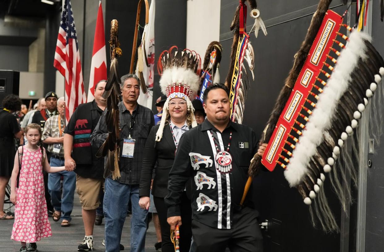 National Chief Cindy Woodhouse Nepinak, second from right, walks during the grand entry at the Assembly of First Nations annual general assembly in Montreal on Tuesday.  (Christinne Muschi/The Canadian Press - image credit)