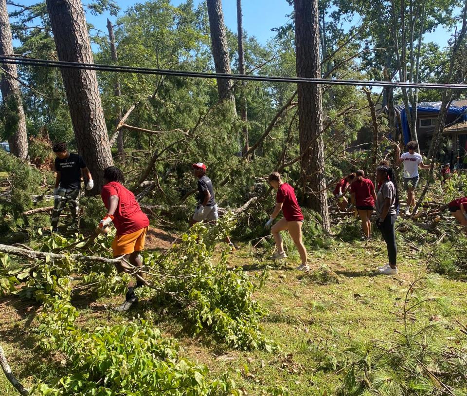 Athletes from Gadsden City High School turned out on Monday to assist with clean-up on Lookout Mountain following last week's severe storm that downed trees and damaged homes in the area.
