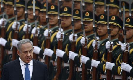 Israel's Prime Minister Benjamin Netanyahu (L) reviews the honour guards during an official welcoming ceremony at the Great Hall of the People in Beijing in this May 8, 2013 file photo. REUTERS/Petar Kujundzic/Files