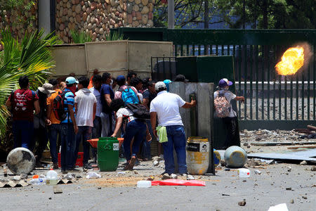 A student from the Universidad Agraria (UNA) public university throws a molotov cocktail at riot police during a protest against reforms that implement changes to the pension plans of the Nicaraguan Social Security Institute (INSS) in Managua, Nicaragua April 19, 2018. REUTERS/Oswaldo Rivas