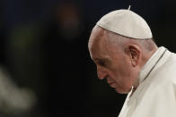 Pope Francis presides over the Via Crucis (Way of the Cross) torchlight procession on Good Friday, a Christian holiday commemorating the crucifixion of Jesus Christ and his death at Calvary, in front of Rome's Colosseum, in Rome, Friday, April 19, 2019. (AP Photo/Andrew Medichini)