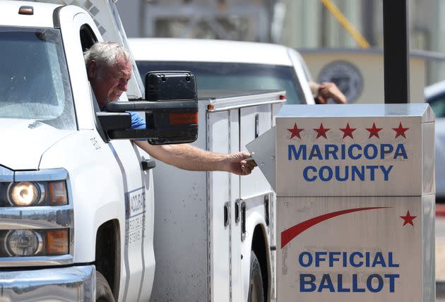 A voter places a ballot in a drop box outside the Maricopa County Elections Department on Aug. 2 in Phoenix. (Photo: Justin Sullivan via Getty Images)