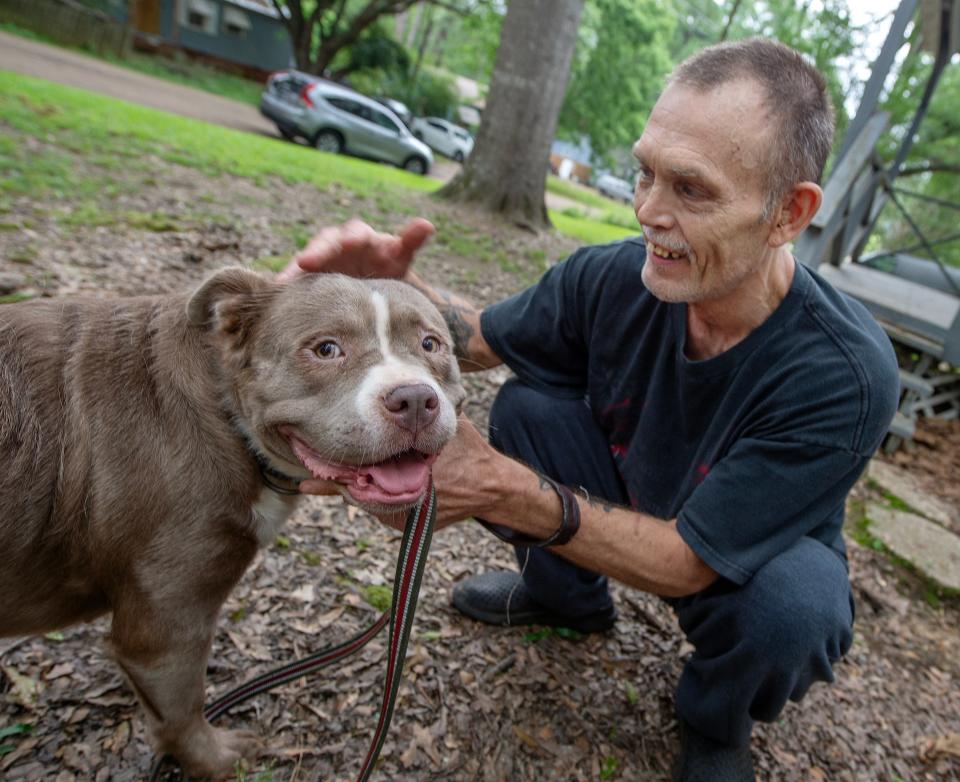 Jeffery Welborn of south Jackson, Miss, has rescued 12 stray dogs. Out of the dozen, he’s kept two. On Wednesday, May 8, 2024, Welborn shows off one of his dogs, Bella, who he describes as a red lion pit bull with long hair. He took the other 10 dogs to a no-kill shelter.