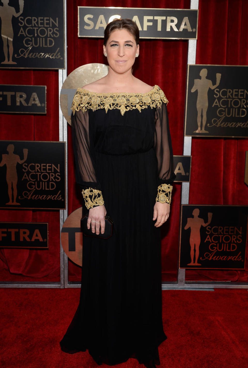 Mayim Bialik in black long-sleeved gown with gold embellishment at the 22nd Annual Screen Actors Guild Awards at The Shrine Auditorium on January 30, 2016 in Los Angeles, California.