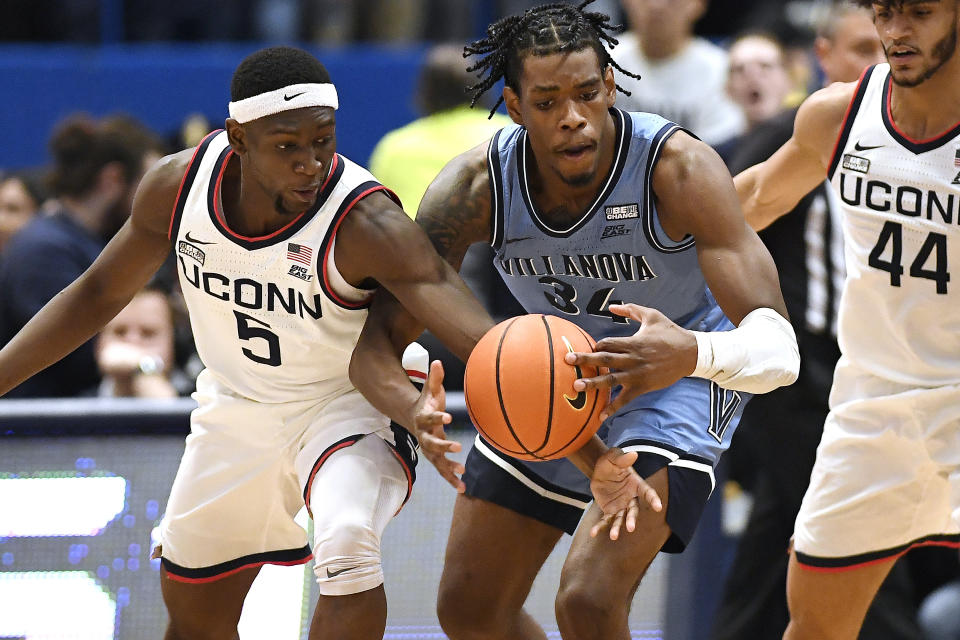 UConn's Hassan Diarra (5) knocks the ball from Villanova's Brandon Slater (34) during the second half of an NCAA college basketball game Wednesday, Dec. 28, 2022, in Hartford, Conn. (AP Photo/Jessica Hill)