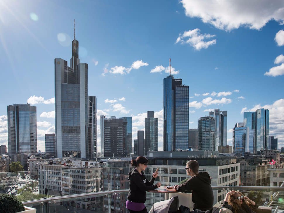 People sit at restaurant roof terrace with the skyline and finance district of Frankfurt's financial district, which locals call 'Mainhattan.'