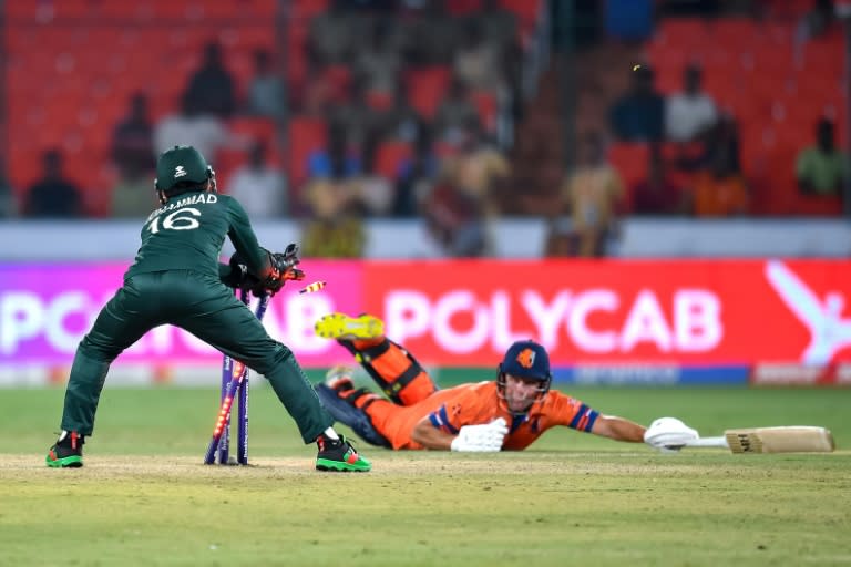 That's out: Pakistan's Mohammad Rizwan runs out Netherlands' Roelof van der Merwe in the opening game (Noah SEELAM)