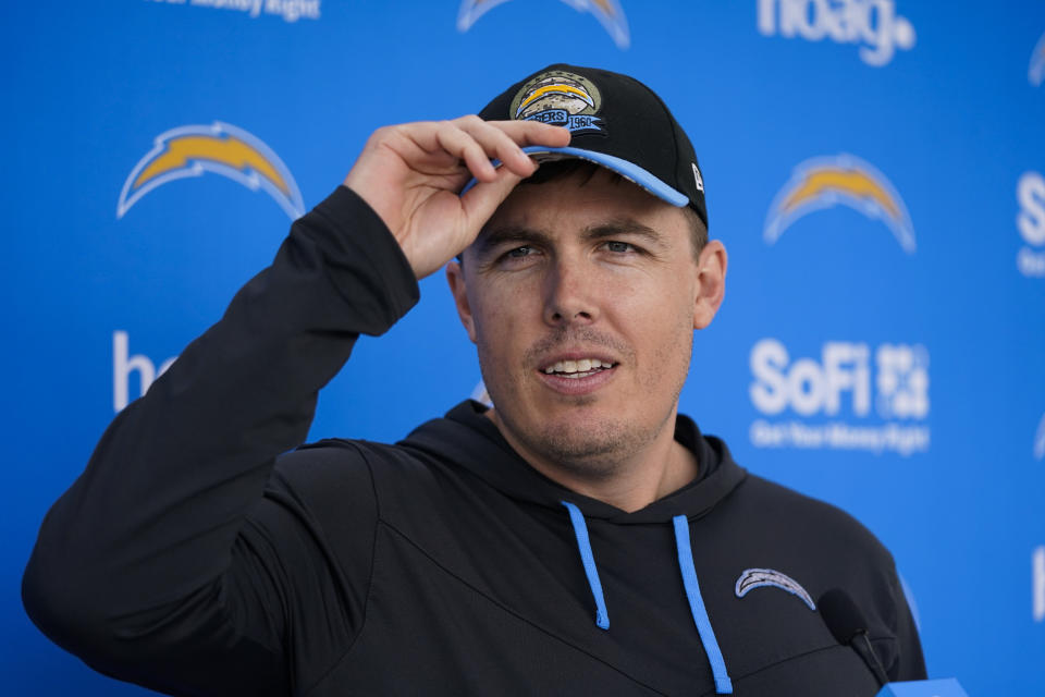 FILE - Los Angeles Chargers offensive coordinator Kellen Moore talks to reporters after the NFL football team's camp Wednesday, May 31, 2023, in Costa Mesa, Calif. Moore is expected to install an offensive scheme that features more downfield passing and more consistency with the running game. (AP Photo/Jae C. Hong, FIle)