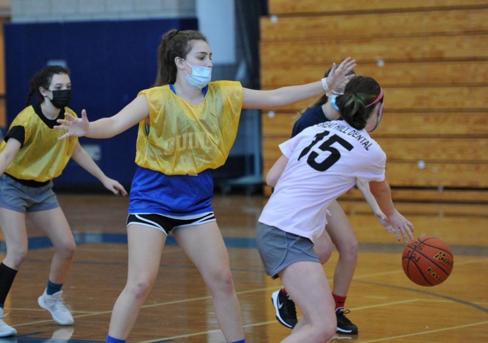 Quincy High School girls basketball player Priscilla Bonica, center, defends during practice, Tuesday, Dec. 22, 2020.