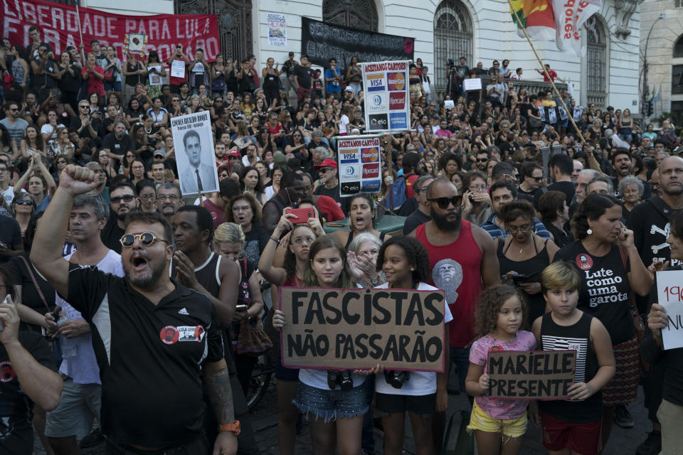 Children hold a sign that reads in Portuguese "Fascists will not pass" during a protest against the military coup of 1964 in Rio de Janeiro, Brazil, Sunday, March 31, 2019. Brazil's president Jair Bolsonaro, a former army captain who waxes nostalgic for the 1964-1985 dictatorship, asked Brazil's Defense Ministry to organize "due commemorations" on March 31, the day historians say marks the coup that began the dictatorship. (AP Photo/Leo Correa)