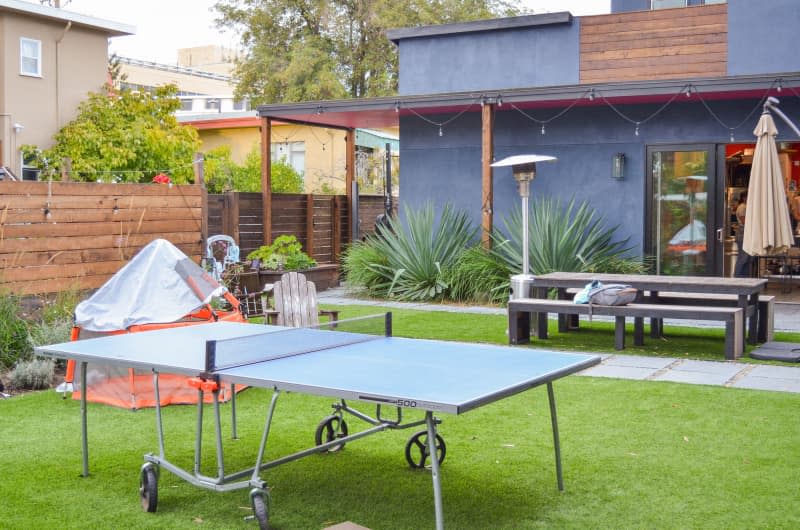 Ping pong table in outdoor area of shared home.