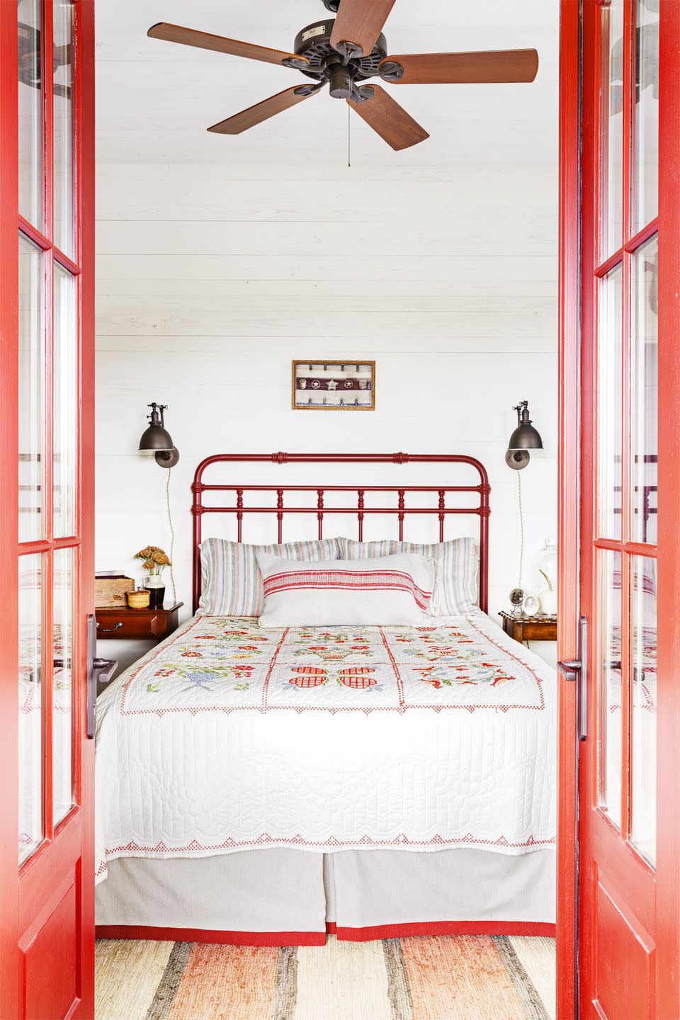 a country bedroom with a ceiling fan