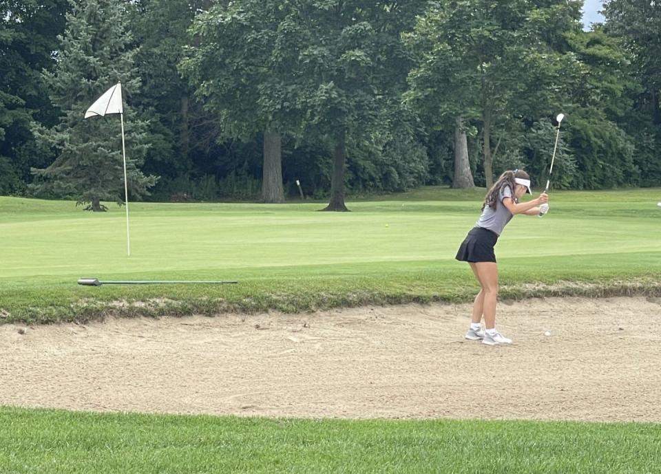 Tori Busen of St. Mary Catholic Central hits out of a sand trap during the Airport Match-Play Tournament at Sandy Creek Monday. SMCC too second to Woodhaven.