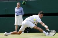 Novak Djokovic of Serbia hits a shot during his match against Bernard Tomic of Australia at the Wimbledon Tennis Championships in London, July 3, 2015. REUTERS/Suzanne Plunkett