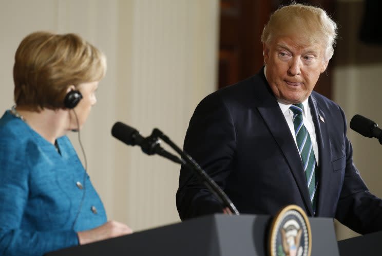 President Trump and German Chancellor Angela Merkel glance at each other during their joint news conference in the East Room of the White House.