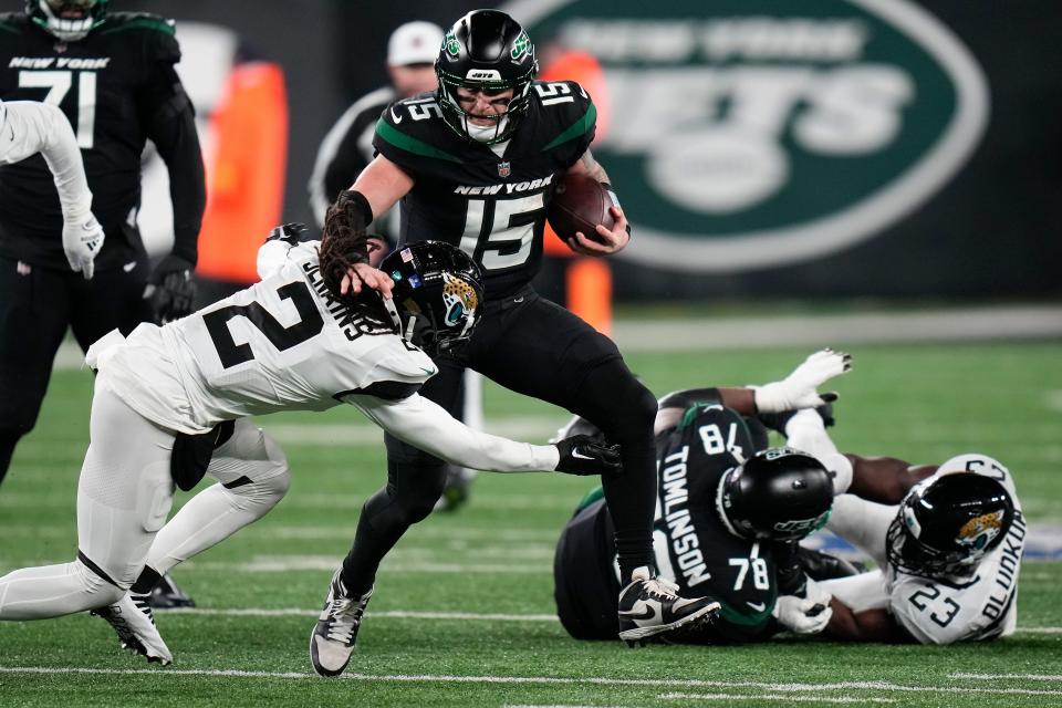 New York Jets quarterback Chris Streveler (15) is tackled by Jacksonville Jaguars safety Rayshawn Jenkins (2) during the fourth quarter of an NFL football game, Thursday, Dec. 22, 2022, in East Rutherford, N.J. (AP Photo/Seth Wenig)