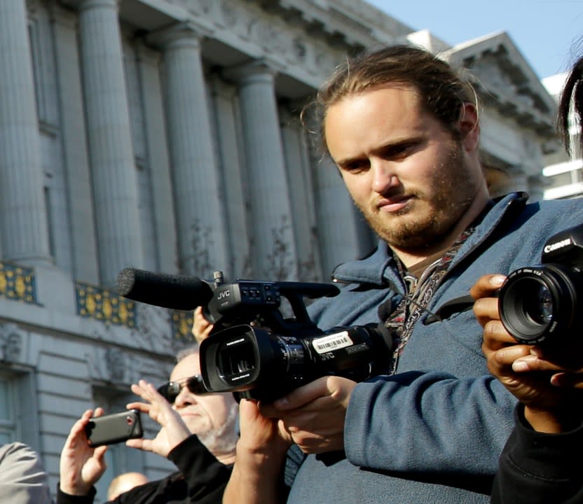 David DePape records Gypsy Taub being led away by police after her nude wedding outside City Hall on Dec. 19, 2013, in San Francisco. (AP Photo / Eric Risberg / File)