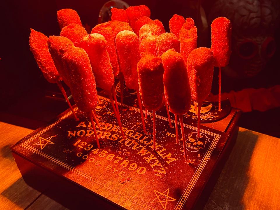 display of churro dogs on sticks at halloween horror nights