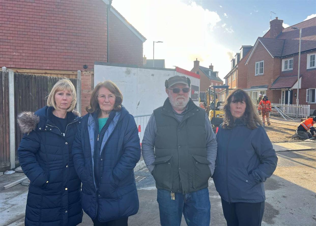 Jo Webb, of Adelaide Drive, and Lydbrook Close residents Ann Smith, Thomas and Janice Cherrett standing in front of the new Moat Homes estate in Sittingbourne. Release date – January 23 2024. See SWNS story SWLShomes. New homes built in the middle of a housing estate have angered residents who claim developers have built them in the wrong place and 1.8m higher than planned. Work on 49 homes on an old chalk quarry in Sittingbourne in Kent began in 2019 with plans to complete them within 18 months. Five years on and with the houses nearly finished locals haven't got what they had expected. Ann Smith and Alan Belsom both own properties along Lydbrook Close near the development. 