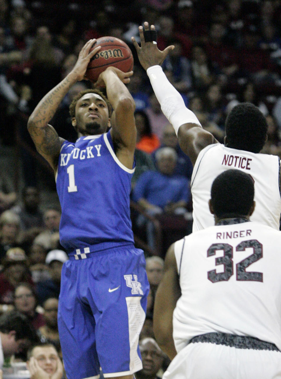 Kentucky's James Young (1) hits his shot as South Carolina's Duane Notice tries to defend during the first half of an NCAA college basketball game Saturday March 1, 2014 in Columbia, S.C. (AP Photo/Mary Ann Chastain)